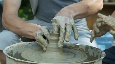 Working with clay at the first stage. The master teaches how to work with cla Stock Footage 125408998