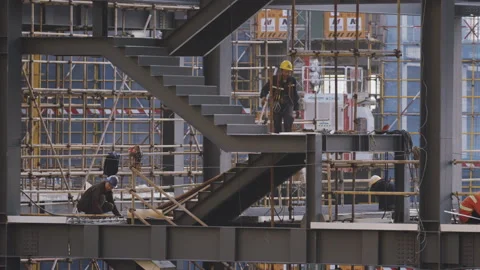 Working Climbs Staircase in Busy Construction Site Stock Footage 224324298