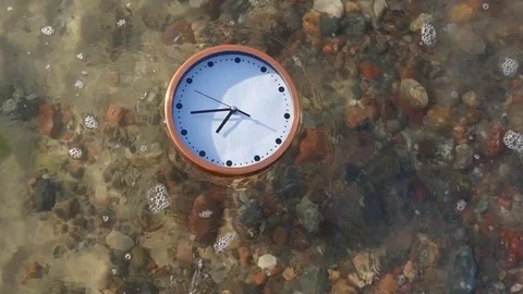 Working clock floating in waves of the sea Stock Footage 75873966
