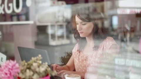 Working in the coffee shop next to the window Stock Footage 70288612