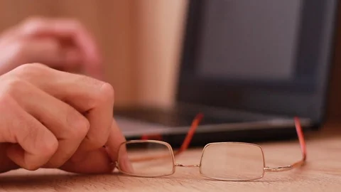 Working on the computer and taking glasses Stock Footage 88763927