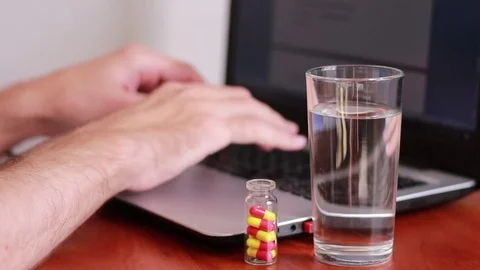 Working on the computer and taking medicine 動画素材 81057751