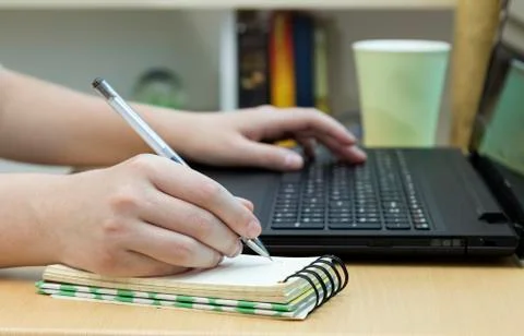 Working on the computer and taking notes in the office, close up Stock Photos