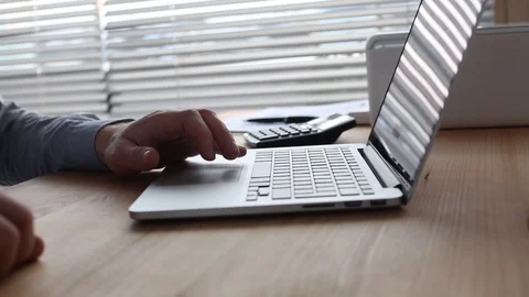 Working on computer, close up of hand dolly shot with camera sliding Stock Footage 127497269