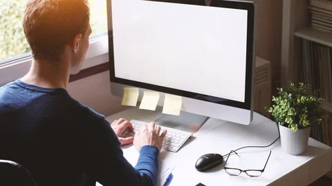 Working on computer with empty blank screen Stock Footage 89929171
