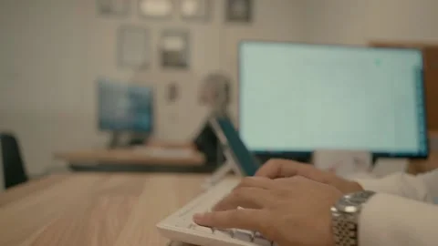 Working on a computer in the office Video stock 220613365