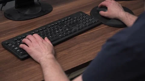 Working on computer over shoulder view in home office Stock Footage 333031087