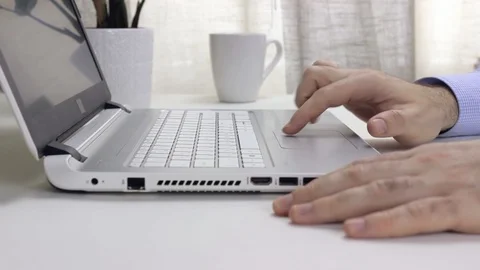 Working on the computer using the touchpad. Remote work in the home office Stock Footage 128104134