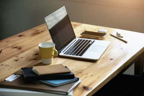 Working concept, computer, coffee mug, books and documents on the desk. Stock Photos