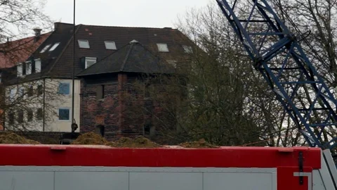 Working at a construction site, a excavator lifting up soil Stock Footage 88550836