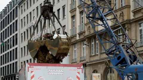 Working at a construction site, a excavator lifting up soil, dirt Stock Footage 88551185