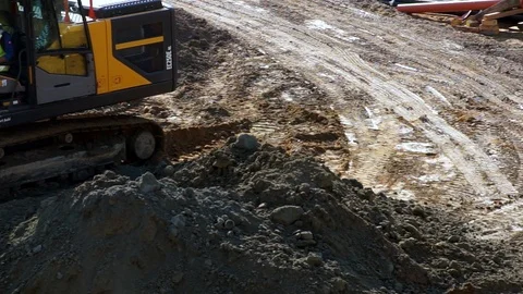 Working at a construction site, a excavator moving soil Stock Footage 88665155