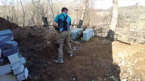 Working on a construction site near a forest in early spring with building block Stock-Footage 332064787