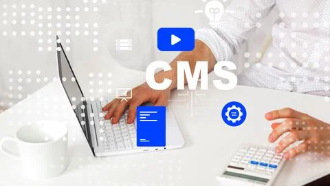Working on a content management system with a laptop and accessories at a desk Stock Photos