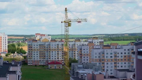 Working crane on construction set of building with heavy house panel on it Stock Footage 278666804