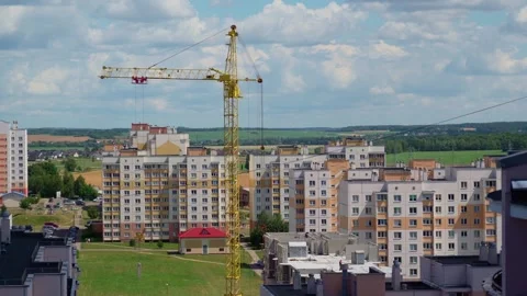 Working crane on construction set of building with heavy house panel on it Stock Footage 278666812
