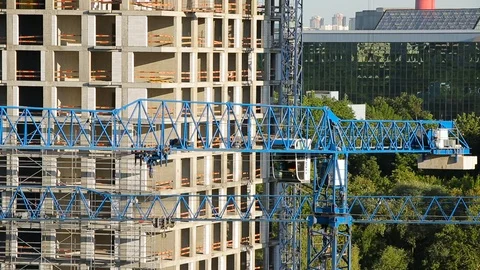 Working cranes on background of multi-storey building under construction Stock Footage 94015619