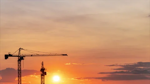 Working cranes close-up against stunning sunset. Time lapse Stock-Footage 313954462