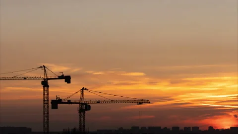 Working cranes silhouettes on the beautiful sunset background at summer night Stock-Footage 313954810