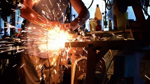 Working that cut with a flex a piece of metal in his home workshop Stock Footage 71097005