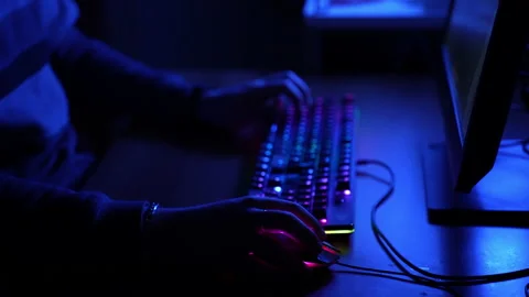 Working in cyber video games sphere, unrecognizable hacker in dark blue Stock-Footage 150023541