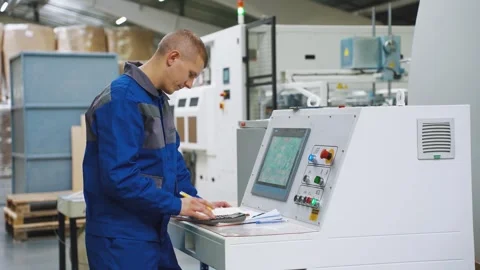 Working day. Employee, worker of corrugated cardboard factory stands near Video stock 281332679