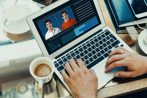Working on deep fake technology at a desk with coffee in a cozy office setting Stock Photos