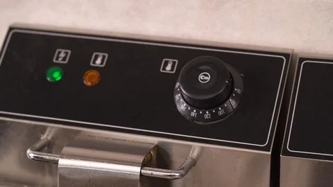 Working deep fryer. Chef is controlling the frying process by temperature sensor Vídeos de archivo 105499560