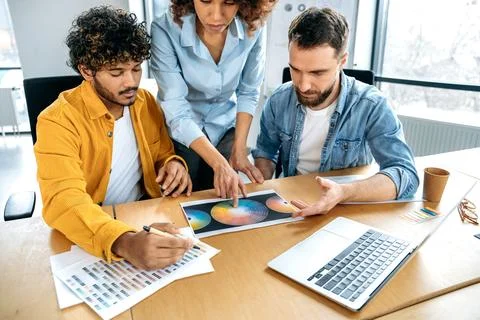 Working on a design project, pantone selection. Teamwork concept. Positive Stock Photos