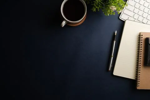 Working desk with diary, keyboard, coffee cup and glasses. Top view with co.. Stock Photos