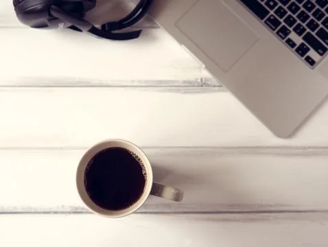 Working desk with notebook and large mug of coffee Stock Photos