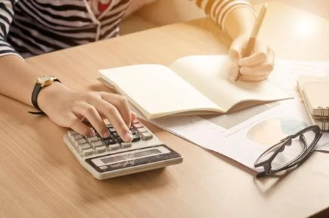 Working on a desk numerical analysis, financial accounting. Graphing Calculat Stock Photos
