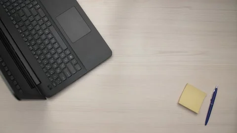 Working desk top view above with notebook laptop and man Stock Footage 169517203