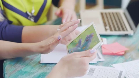 Working disorder on the table. Mini-tablet computer in female hands Video stock 78124495