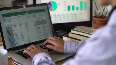 Working on a document with two monitors Video stock 80317796