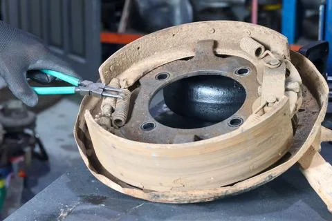 Working on Drum Brake Assembly with Pliers. Stock Photos