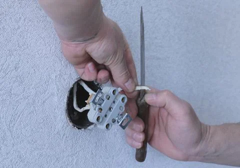 Working with an electric cable with a kitchen knife Stock Photos