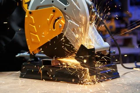 Working electric cutting disc machine with sparks flying in different directions Stock Photos