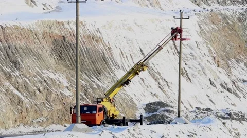 A working electrician does his job while on a car lift. Stock Footage 124192569