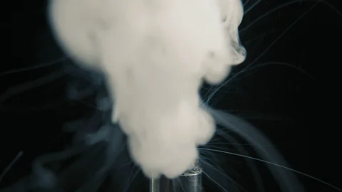 Working electronic cigarette. Macro of coil in RTA, steam in slowmotion. Vape 動画素材 103112202