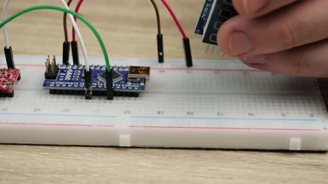 Working with electronics microcircuits on a breadboard, the hand of a white m Stock Footage 150268026