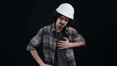 The working engineer has a sharp heartache, he is holding his hands on the left Video stock 155975353
