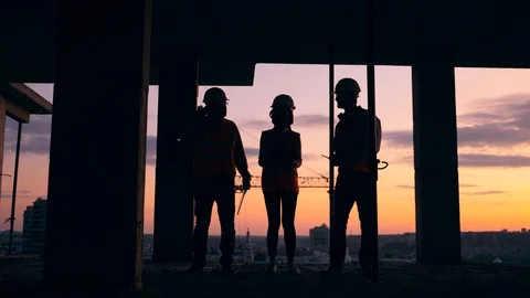 Working engineers talk while standing in a building. Stock Footage 124305509