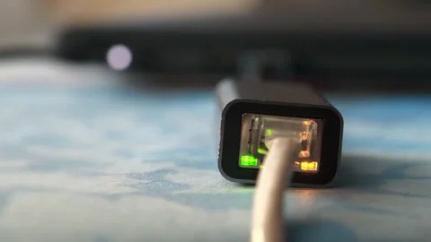Working ethernet cable adapter with green LED and flashing yellow LED Stock Footage 279249368