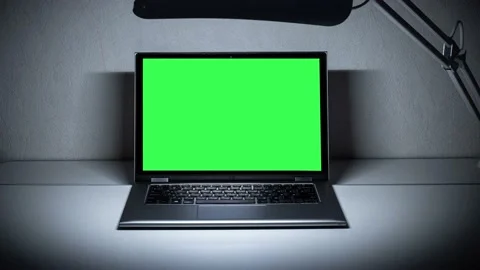 Working in the evening. Laptop with green screen. Zoom in. Template for keying Stock Footage 150859017