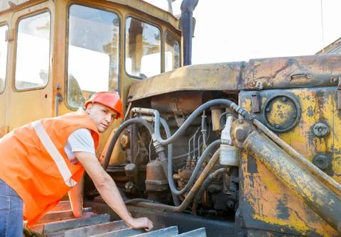Working  examining bulldozer engine Stock Photos