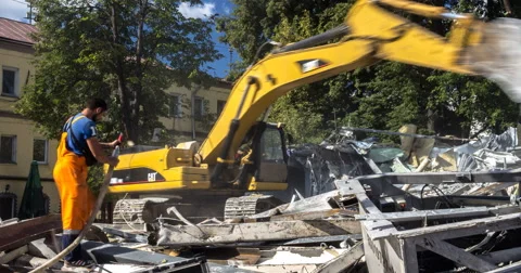 Working of excavator by demolition of building Stock Footage 67144411