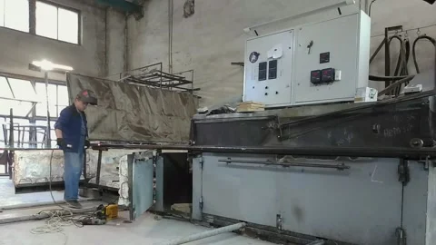 Working at the factory with a welding machine and protective mask. 스톡 동영상 130430982