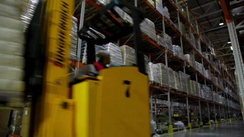 Working forklift inside a huge warehouse Stock Footage 90994712