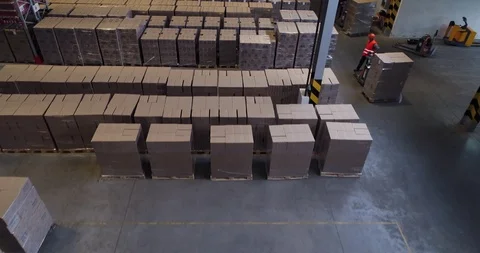 Working forklift loader inside huge industrial warehouse. Aerial shooting. Stock Footage 119926874